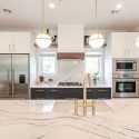 Kitchen renovation with custom cabinets and stone countertops, showing how cabinetry layout defines the finished kitchen design