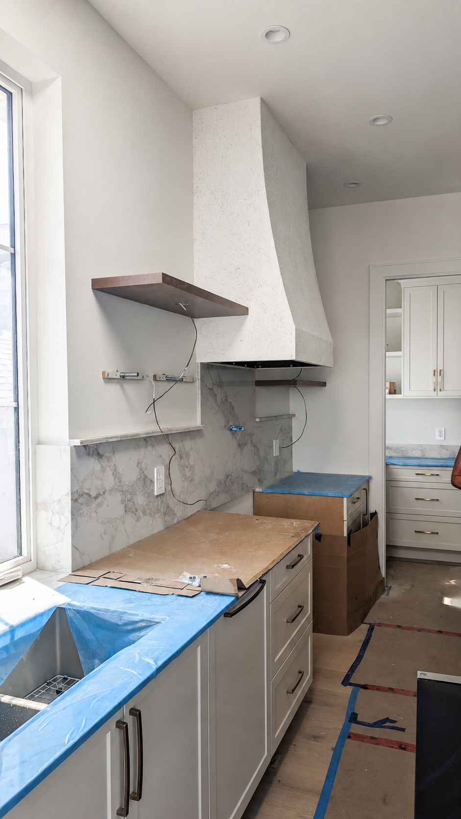 Clear covered garage workspace prepared for kitchen cabinet installation